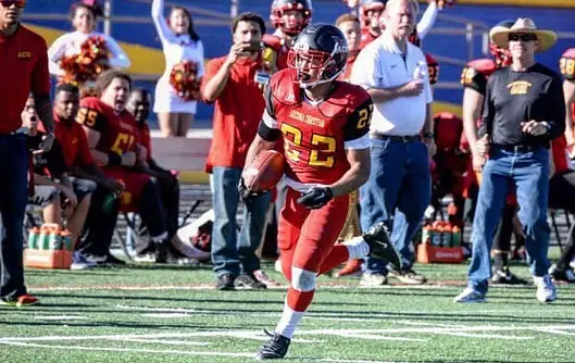 PJ’s football years, pictured in a red and yellow uniform on the field